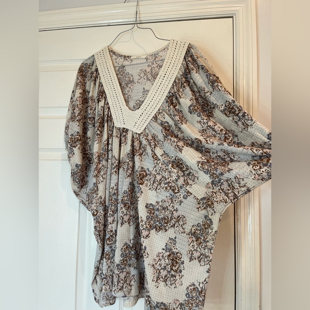 This top is a flowered short sleeve blouse and a v-neck